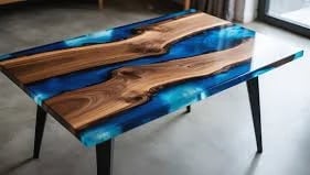 Modern wooden table with blue resin inlay and black legs on concrete floor